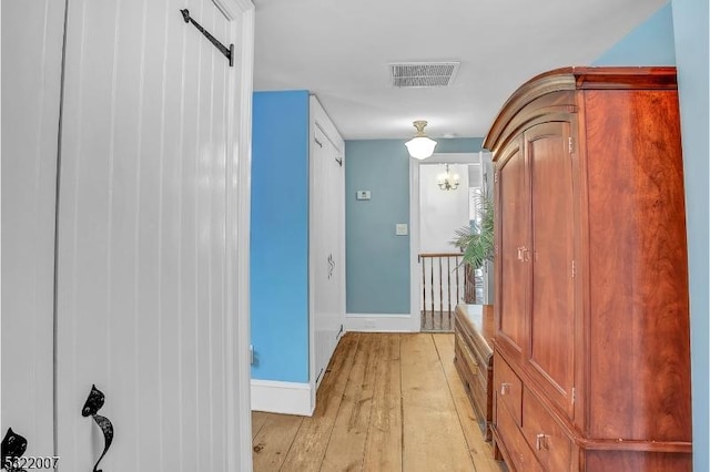 corridor with light hardwood / wood-style floors