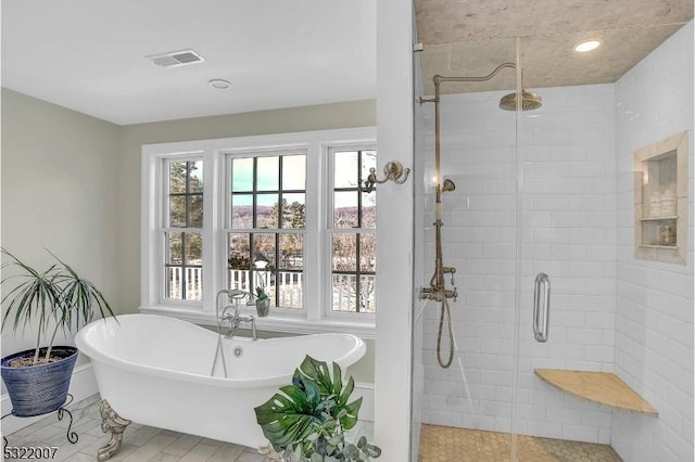 bathroom featuring separate shower and tub