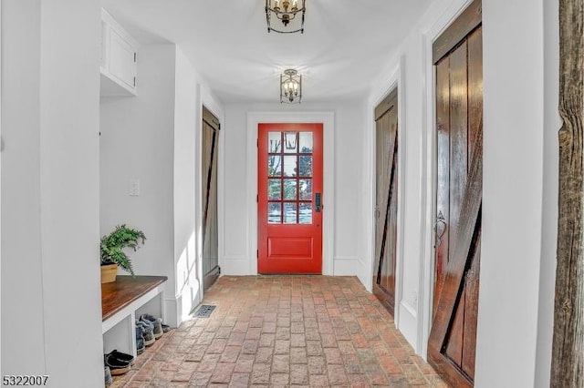 mudroom featuring a chandelier