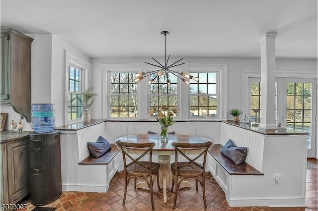 dining room featuring breakfast area, a wealth of natural light, and a chandelier