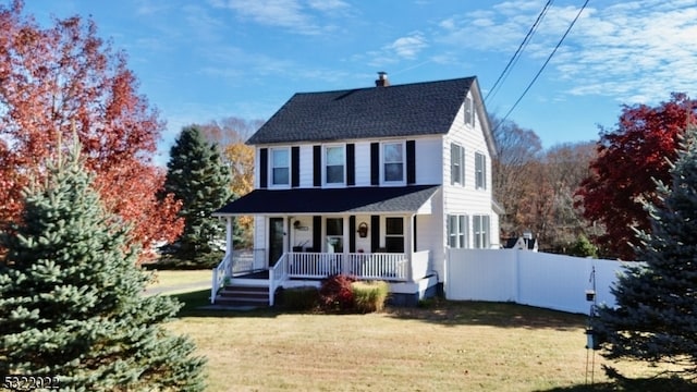 view of front of home with a front yard and covered porch