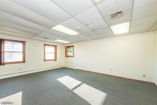 74 S Powder Mill Rd, Parsippany-Troy Hills Twp, NJ 07950 - unfurnished room with dark carpet, baseboard heating, baseboards, and a paneled ceiling