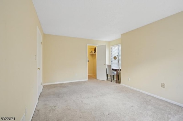 empty room with baseboards and carpet floors