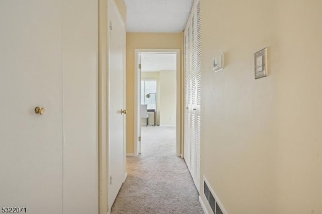 corridor with light colored carpet and visible vents