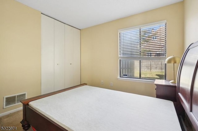 bedroom featuring visible vents and carpet