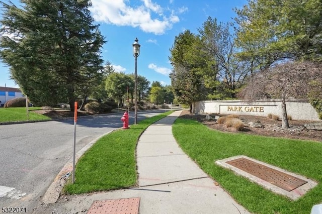 exterior space featuring curbs, sidewalks, and street lighting