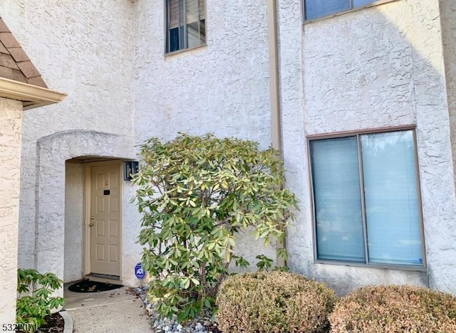 doorway to property with stucco siding