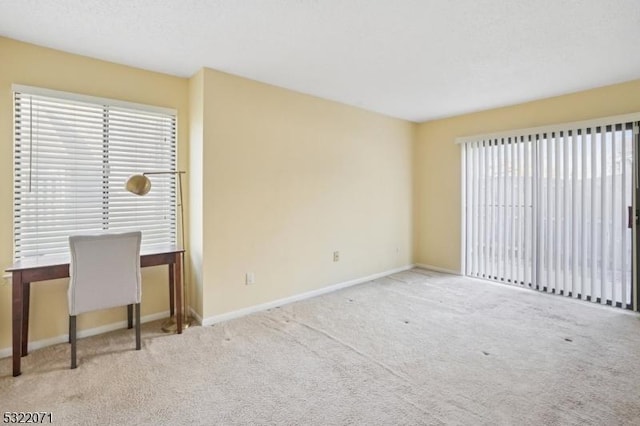 interior space with carpet flooring and baseboards