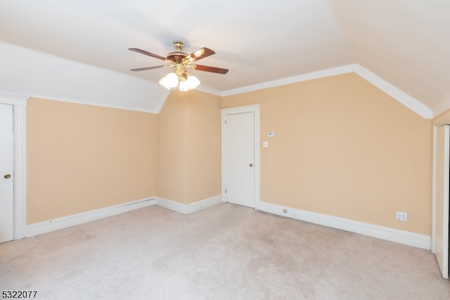 additional living space featuring ceiling fan, light carpet, and vaulted ceiling