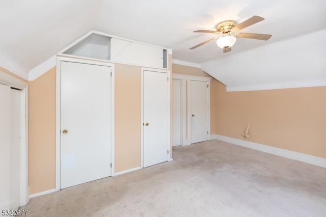 additional living space featuring lofted ceiling, light carpet, and ceiling fan