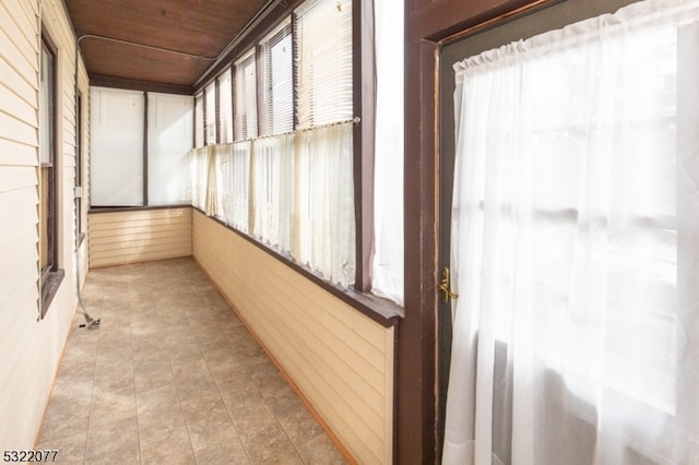 unfurnished sunroom featuring wood ceiling