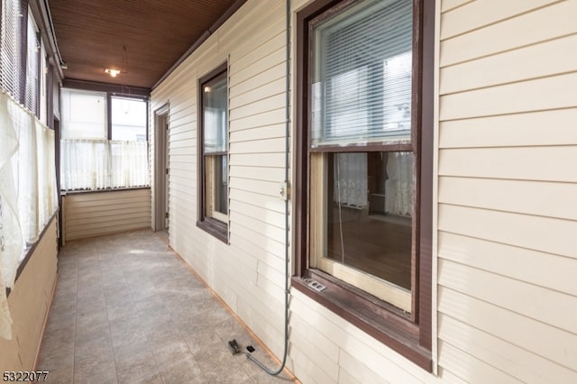 view of side of home featuring covered porch