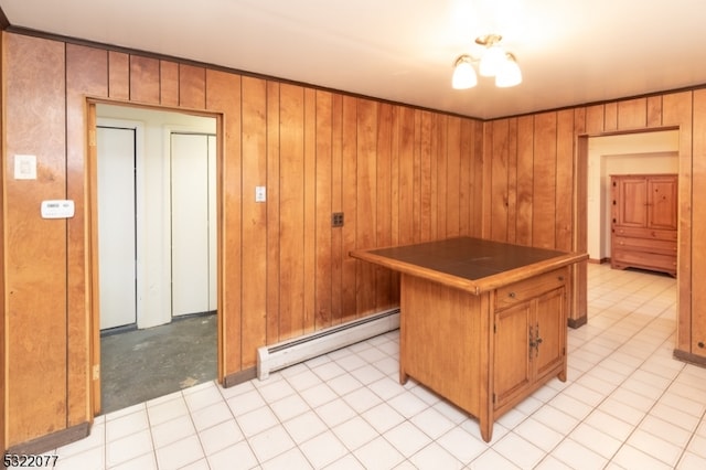 kitchen with wood walls, light colored carpet, and a baseboard radiator