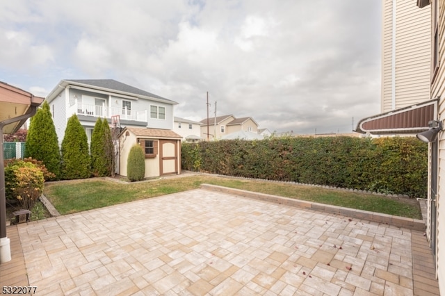 view of patio with a storage unit