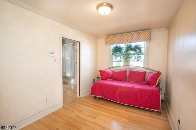 bedroom with crown molding and light hardwood / wood-style flooring