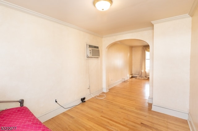 interior space featuring ornamental molding, an AC wall unit, a baseboard radiator, and hardwood / wood-style flooring