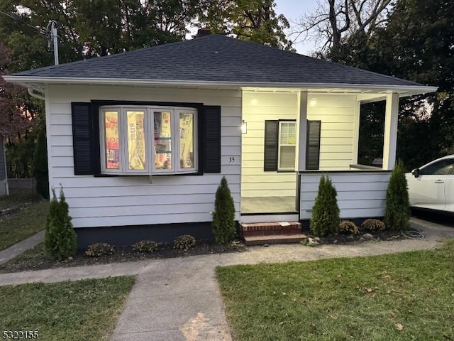 bungalow-style home featuring roof with shingles