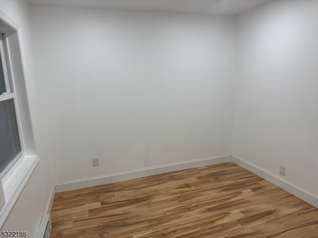 unfurnished room featuring wood finished floors and baseboards