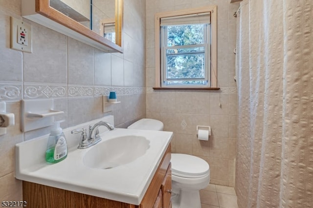 bathroom featuring tile walls, toilet, vanity, a shower with curtain, and tile patterned flooring