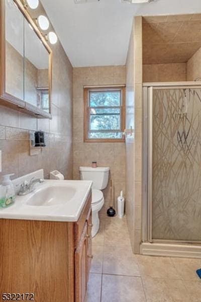 110 Central, Rochelle Park Twp, NJ 07662 - full bath featuring vanity, tile patterned flooring, a shower stall, toilet, and tile walls