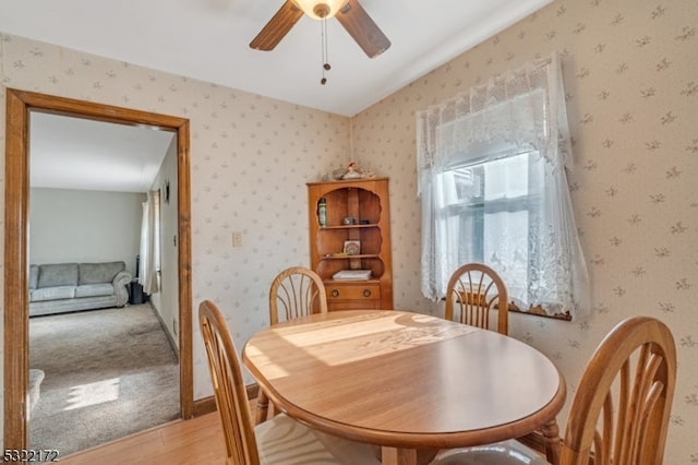 dining space featuring lofted ceiling, hardwood / wood-style flooring, and ceiling fan