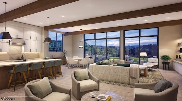 living room with light hardwood / wood-style flooring, beam ceiling, and sink