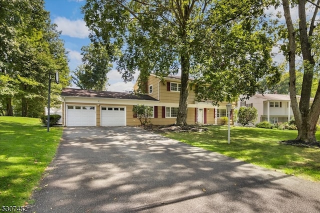 view of front facade with a garage and a front yard