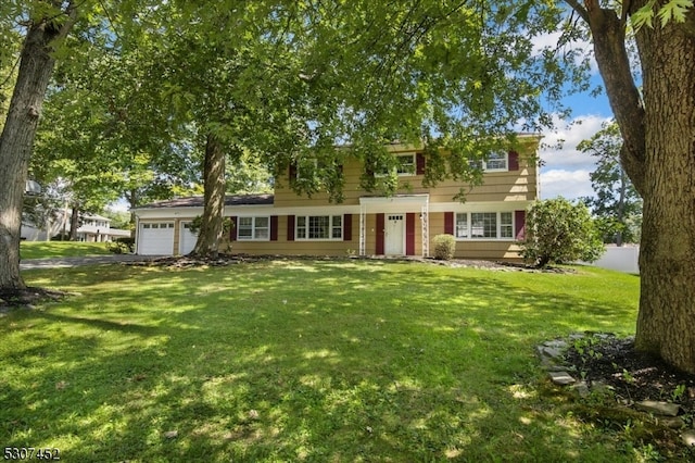 view of front of property featuring a garage and a front lawn