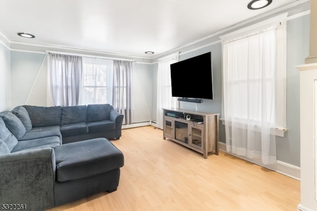 living room with light hardwood / wood-style floors, ornamental molding, baseboard heating, and a fireplace