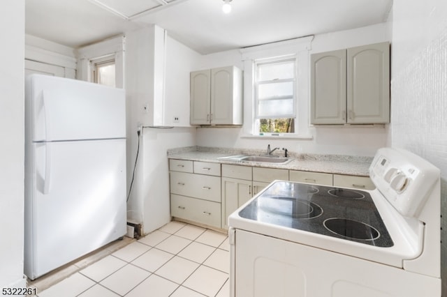 kitchen featuring sink, white appliances, and light tile patterned floors