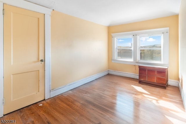 empty room with light hardwood / wood-style floors