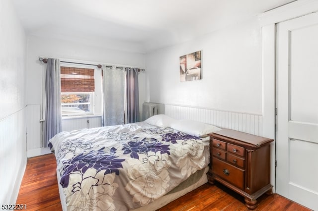 bedroom with dark hardwood / wood-style floors