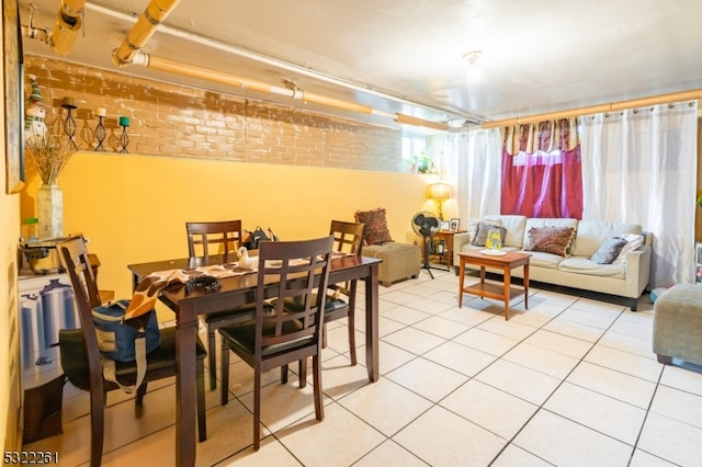 tiled dining space with brick wall