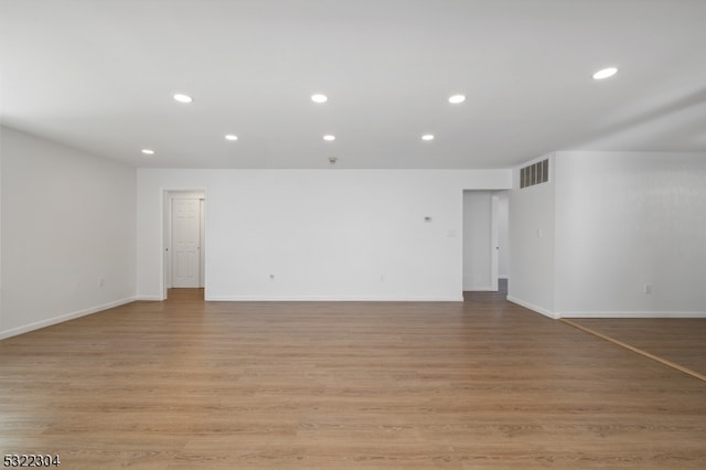 unfurnished room with light wood-type flooring