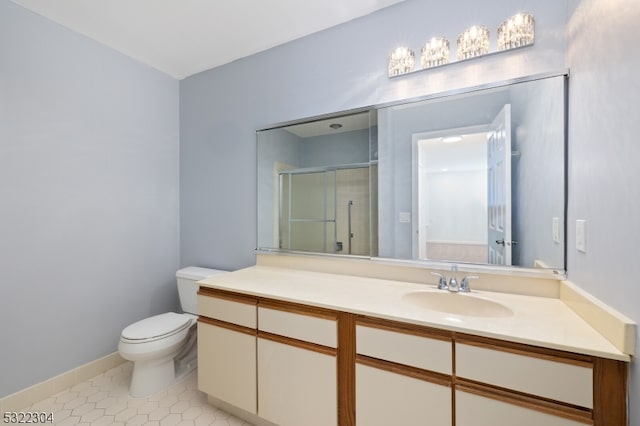 bathroom with tile patterned flooring, vanity, toilet, and walk in shower