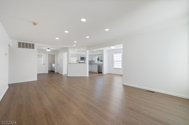 unfurnished living room with wood-type flooring