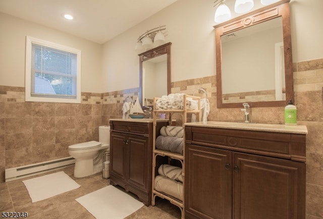 bathroom with toilet, baseboard heating, and tile walls