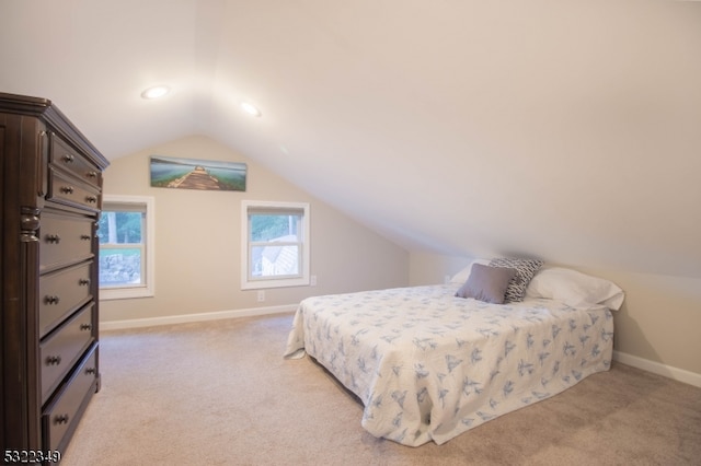 carpeted bedroom featuring lofted ceiling