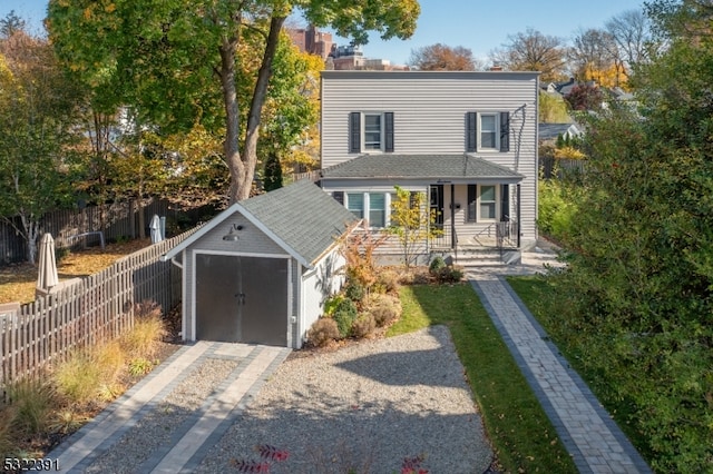 view of front of home with a porch and a shed