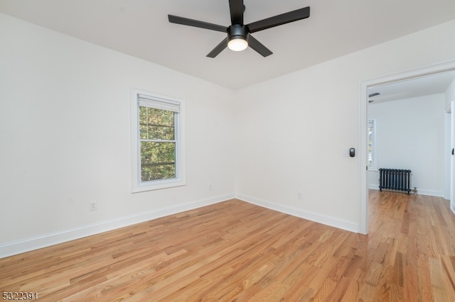 empty room with light hardwood / wood-style flooring and ceiling fan