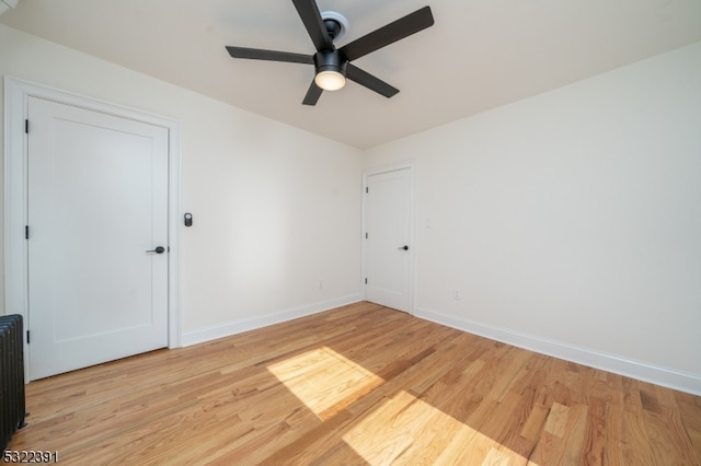 spare room with light hardwood / wood-style floors and ceiling fan