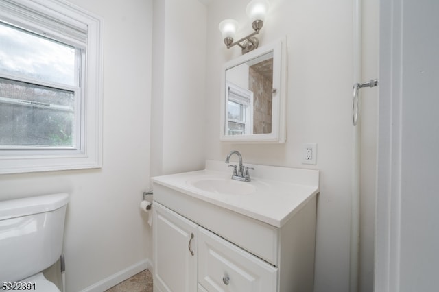 bathroom featuring tile patterned flooring, vanity, and toilet