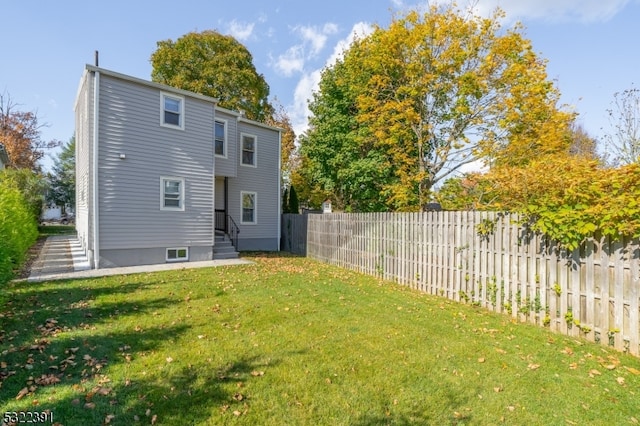 rear view of property with a yard