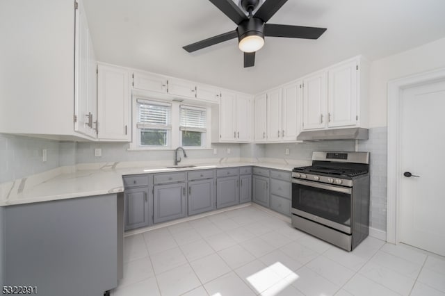 kitchen with white cabinetry, gray cabinets, gas range, sink, and ceiling fan