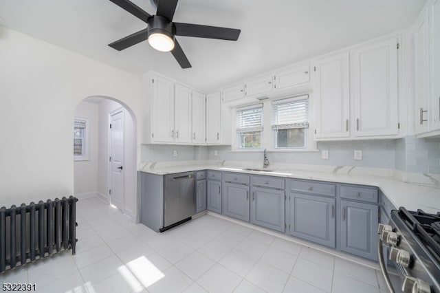 kitchen featuring white cabinetry, appliances with stainless steel finishes, ceiling fan, gray cabinets, and decorative backsplash