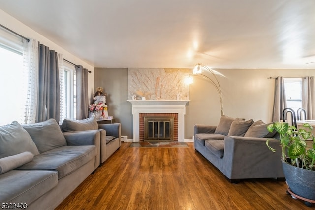 living room with a fireplace and dark wood-type flooring