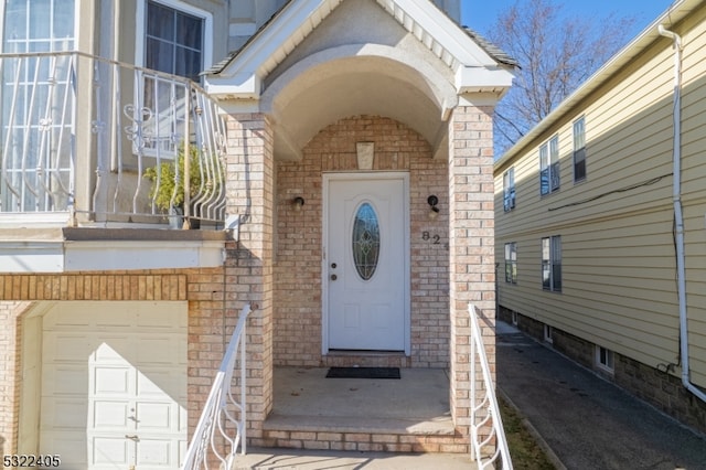 view of exterior entry with a garage