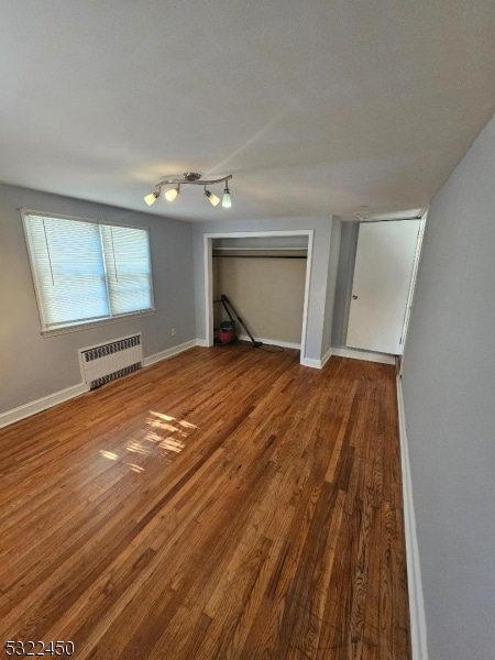 interior space with hardwood / wood-style floors and radiator