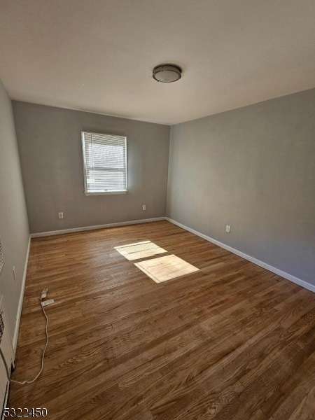 spare room with dark hardwood / wood-style flooring