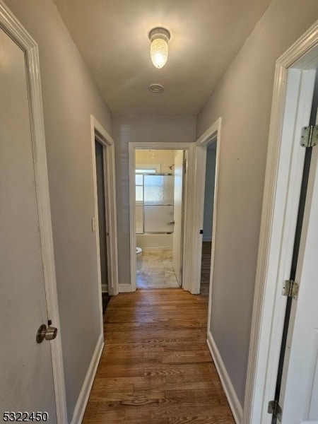 corridor featuring hardwood / wood-style flooring